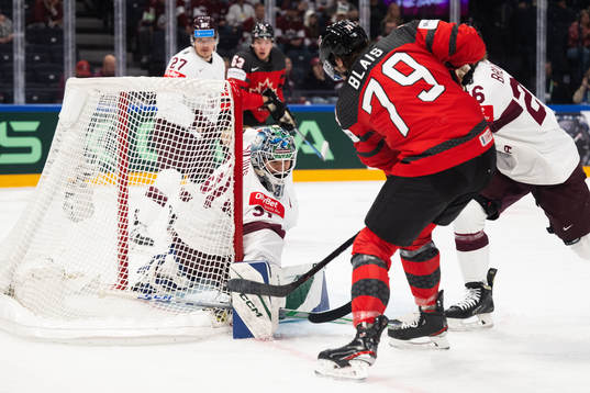 Goaltender Arturs Silovs of Latvia against Samuel Blais of