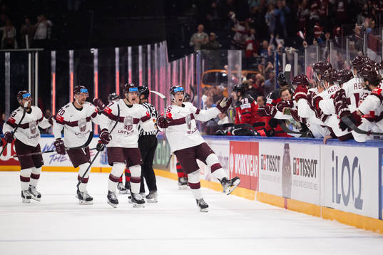 Dans Locmelis of Latvia celebrates with team mates