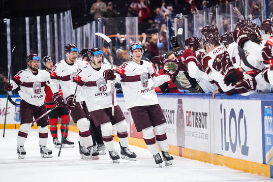 Dans Locmelis of Latvia celebrates with team mates