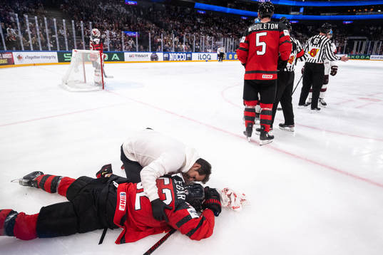 MacKenzie Weegar of Canada receives medical attention