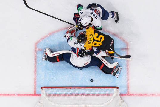 Goaltender Casey Desmith and Henry Thrun of USA are being