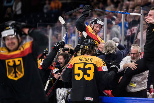 Moritz Seider and Marcel Noebels of Germany celebrate with