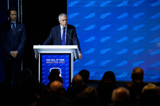 Luc Tardif, president of the IIHF, holding a speech