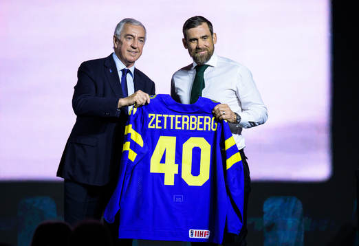 Luc Tardif, president of the IIHF, hands over a Swedish