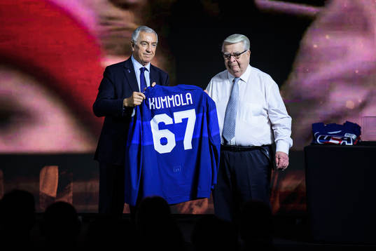 Luc Tardif, president of the IIHF, hands over a Finnish
