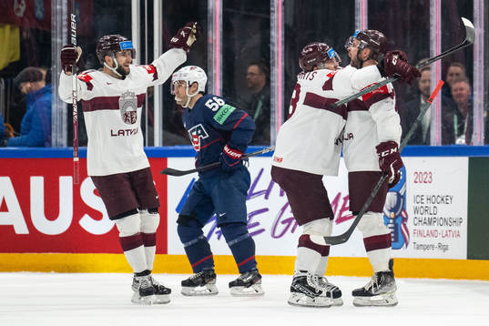 Roberts Bukarts of Latvia celebrates with teammates