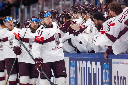 Roberts Bukarts of Latvia celebrates with teammates