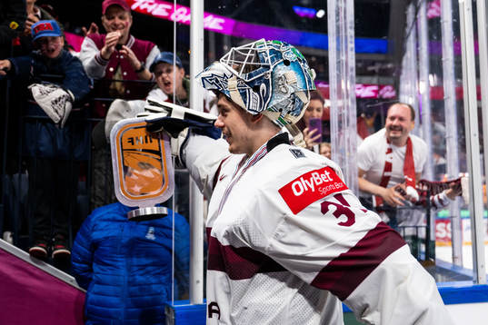Goaltender Arturs Silovs of Latvia celebrate