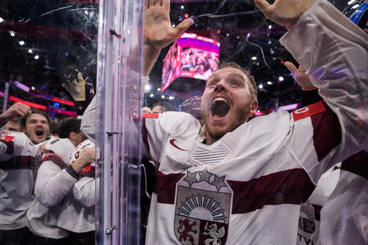 Karlis Cukste of Latvia celebrates with teammates