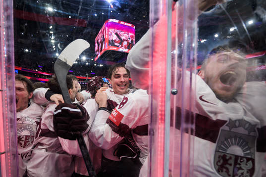 Kristians Rubins of Latvia celebrates with teammates
