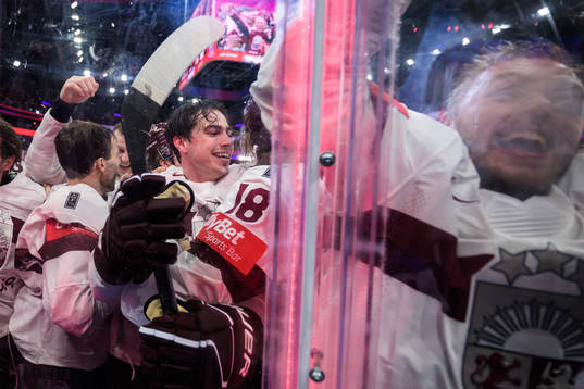 Kristians Rubins of Latvia celebrates with teammates