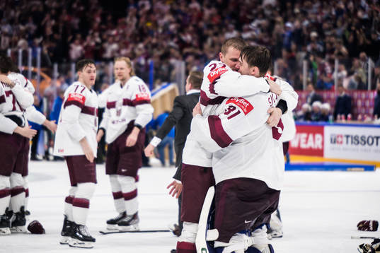 Toms Andersons and goaltender Arturs Silovs of Latvia
