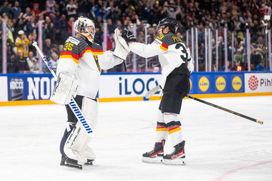 Goaltender Mathias Niederberger and John Peterka of Germany