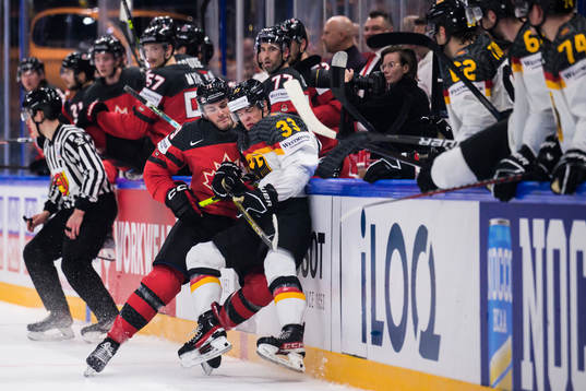 Samuel Blais of Canada tackles John Peterka of Germany