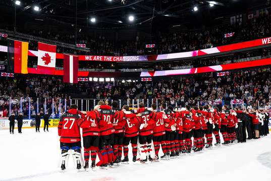 Players of Canada sees the flags of Germany, Canada and