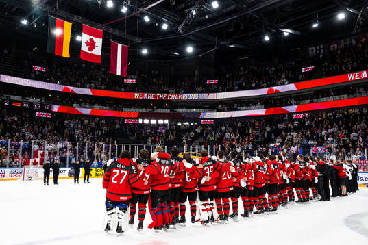 Players of Canada sees the flags of Germany, Canada and