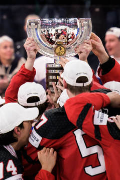 Players of Canada hoist the winner’s trophy