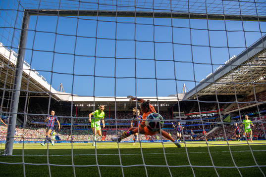 Alexandra Popp of Wolfsburg scores 0-2  behind goalkeeper