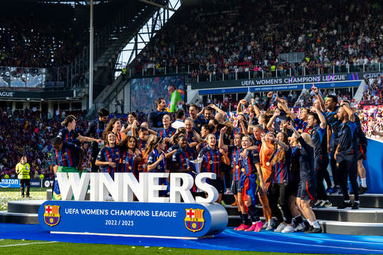 Players of Barcelona celebrate with the trophy