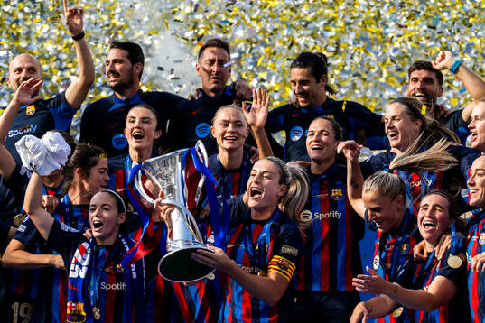 Players of Barcelona celebrate with the trophy