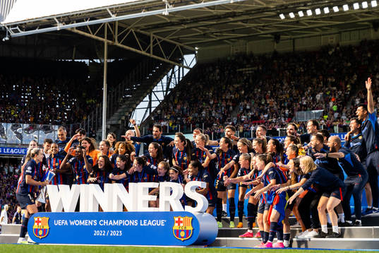 Players of Barcelona celebrate with the trophy