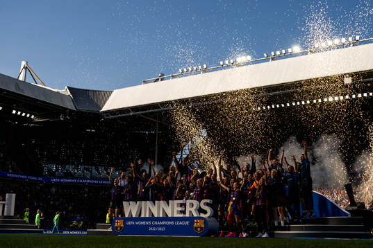 Players of Barcelona celebrate with the trophy