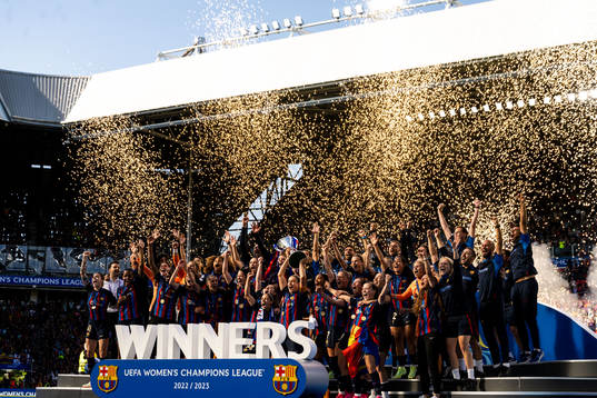 Players of Barcelona celebrate with the trophy