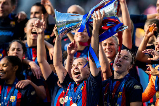 Player of Barcelona celebrates with the trophy