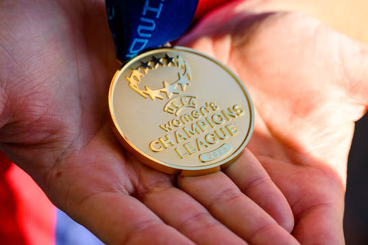 A UEFA Women's Champions League gold medal in the hands of