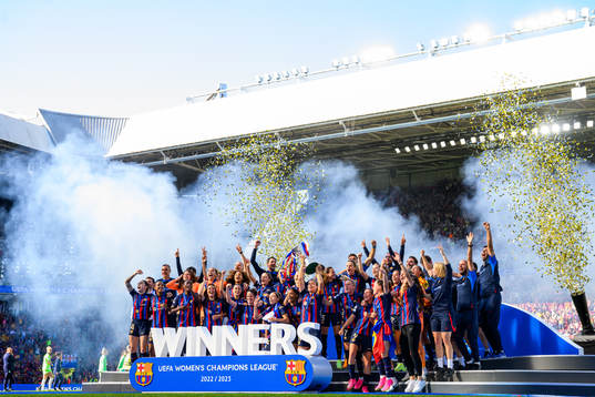 Players of Barcelona lift the trophy