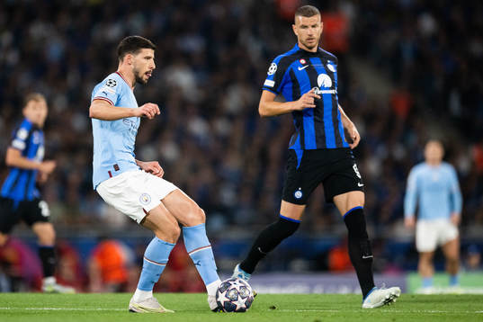 Ruben Dias of Manchester City and Edin Dzeko of Inter