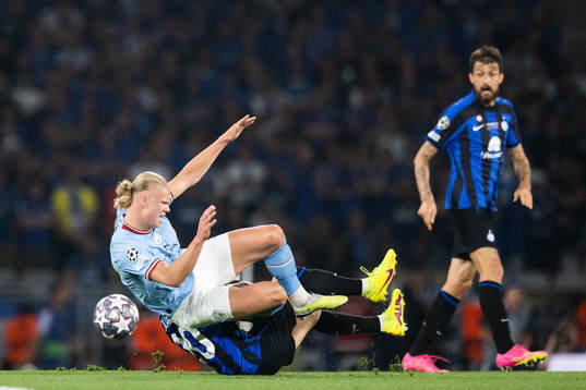 Hakan Calhanoglu of Inter and Erling Braut Haaland of