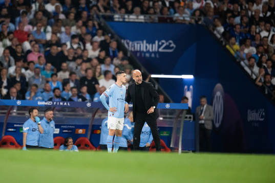 Phil Foden and Head coach Pep Guardiola of Manchester City