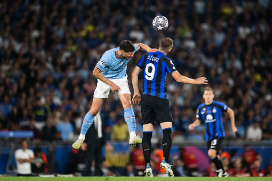 Ruben Dias of Manchester City and Edin Dzeko of Inter