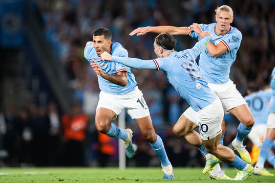 Rodri of Manchester City celebrates with Jack Grealish and