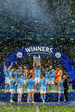 Players of Manchester City celebrate with the trophy