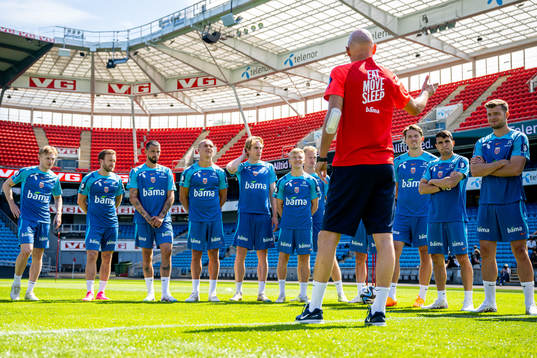 Players of the Norwegian national football team listen to