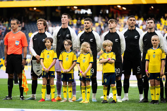 Mascots infront of players of New Zealand