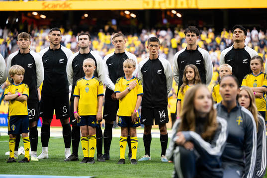 Mascots infront of players of New Zealand