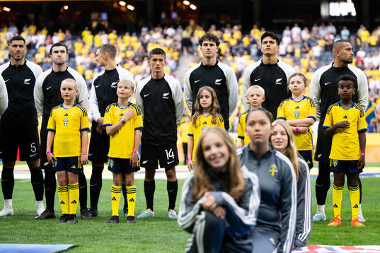 Mascots infront of players of New Zealand