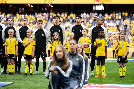 Mascots infront of players of New Zealand