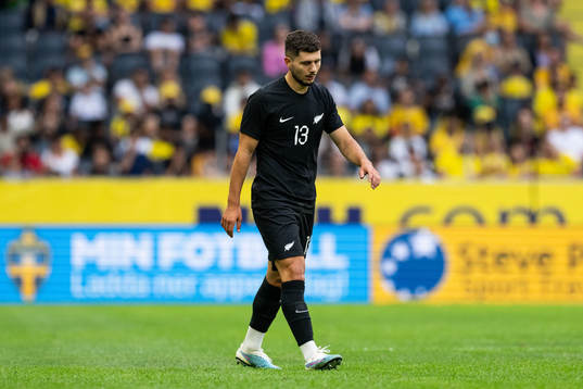 Liberato Cacace of New Zealand looks dejected