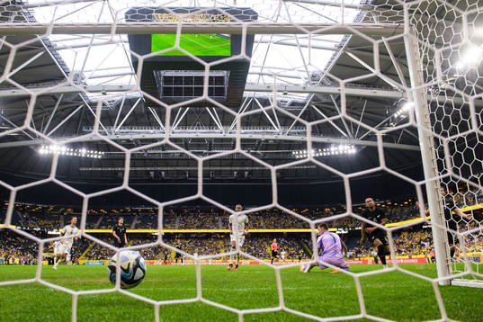 Robin Quaison of Sweden scores 2-1 behind goalkeeper Oli
