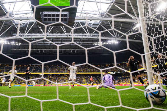 Robin Quaison of Sweden scores 2-1 behind goalkeeper Oli