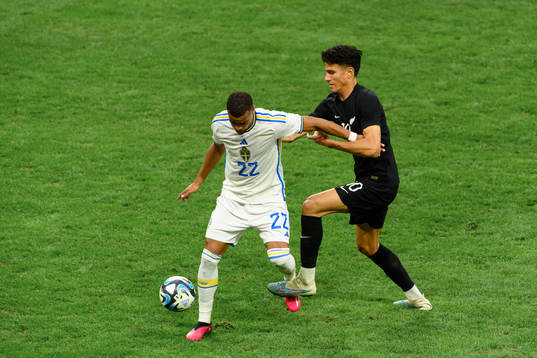 Robin Quaison of Sweden and Marko Stamenic of New Zealand