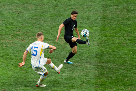 Carl Starfelt of Sweden and Marco Rojas of New Zealand