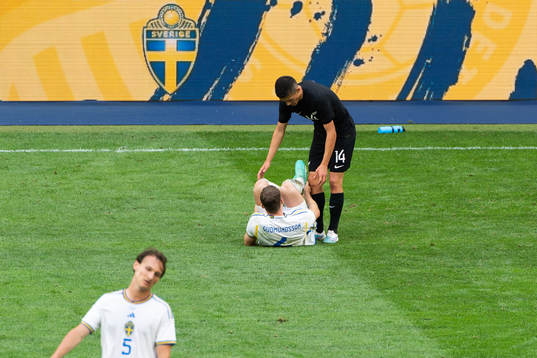Gabriel Gudmundsson of Sweden in pain and Elijah Just of