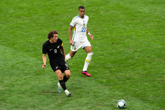 Joe Bell of New Zealand and Robin Quaison of Sweden