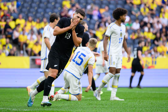 Liberato Cacace of New Zealand looks dejected