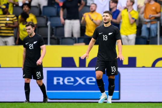 Tim Payne and Liberato Cacace of New Zealand look dejected